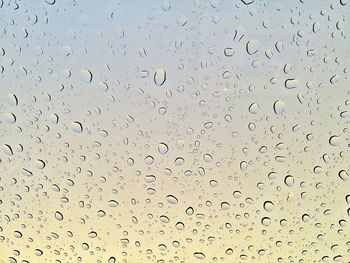Full frame shot of raindrops on windshield
