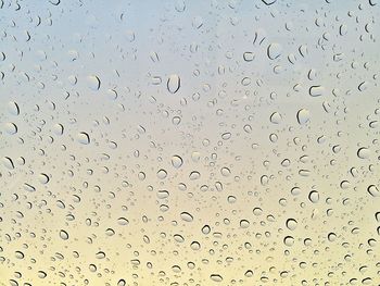 Full frame shot of raindrops on windshield