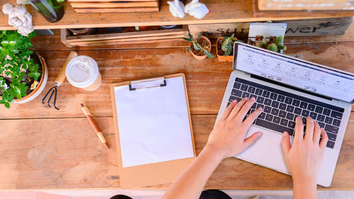 High angle view of man using smart phone on table