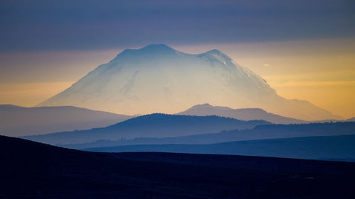 Scenic view of mountains against sky during sunset