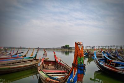 Boats moored in sea against sky