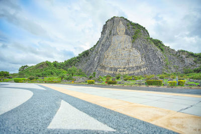 Road by mountain against sky