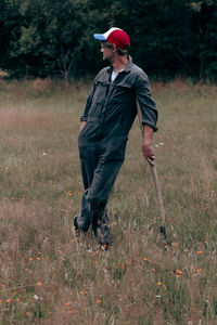 Side view of man standing on field