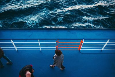 Directly above shot of people walking on ferry over sea