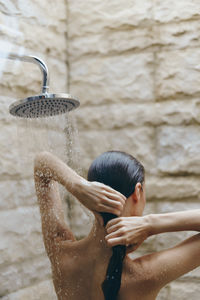 Rear view of man swimming in water