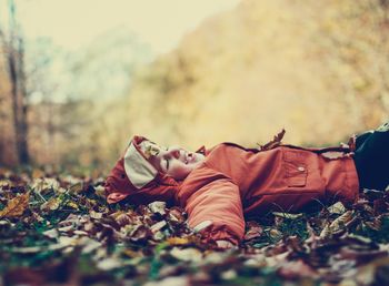 Low section of man lying down on land during autumn