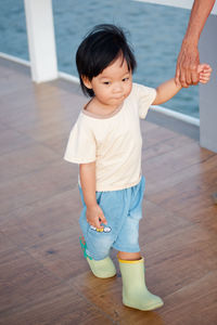 Portrait of boy standing on floor