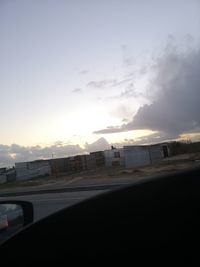 Car on road against sky during sunset