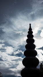 Low angle view of silhouette stack against sky
