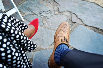 Low section of woman standing on footpath