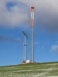 Low angle view of communications tower against sky