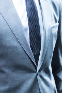 Midsection of man wearing suit