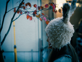 Side view of woman wearing bunny headwear