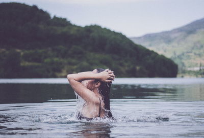 Side view of woman swimming in lake
