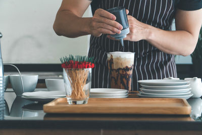 Midsection of woman preparing food on table