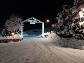 View of snow covered road at night