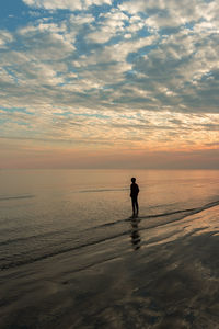 A boy standing on the beach