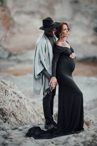 Rear view of couple standing on rock