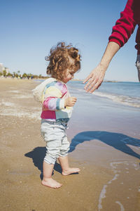 Side view of girl standing at beach