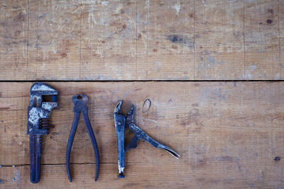 High angle view of rusty tools on wooden table