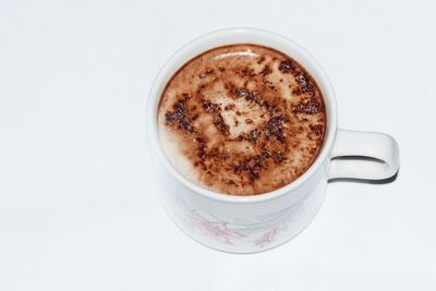 Close-up of coffee cup against white background