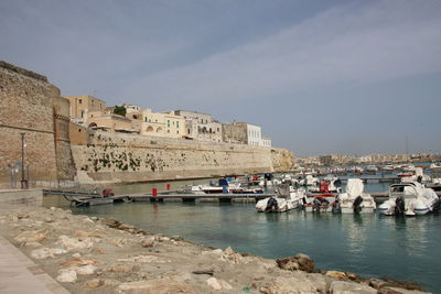 Boats in water against sky