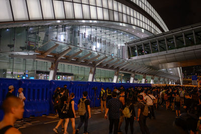 People walking in illuminated city at night