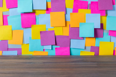 Close-up of multi colored adhesive notes on bulletin board in office