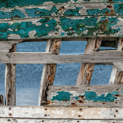 Close-up of rusty metallic structure by sea