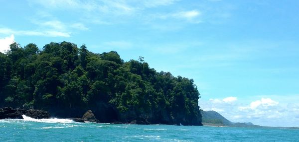 Scenic view of calm sea against cloudy sky