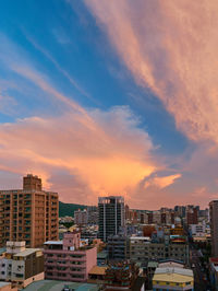 High angle view of buildings against sky during sunset in city