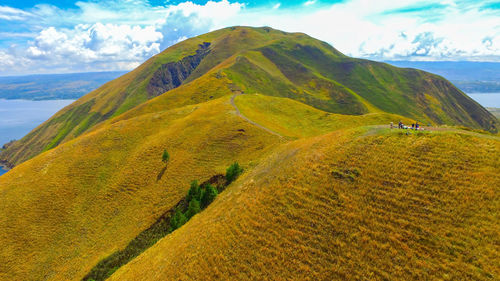 Scenic view of sea and mountains against sky