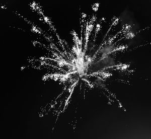 Low angle view of firework display at night