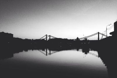 Built structure by river against clear sky