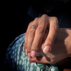 Close-up of woman hands against black background