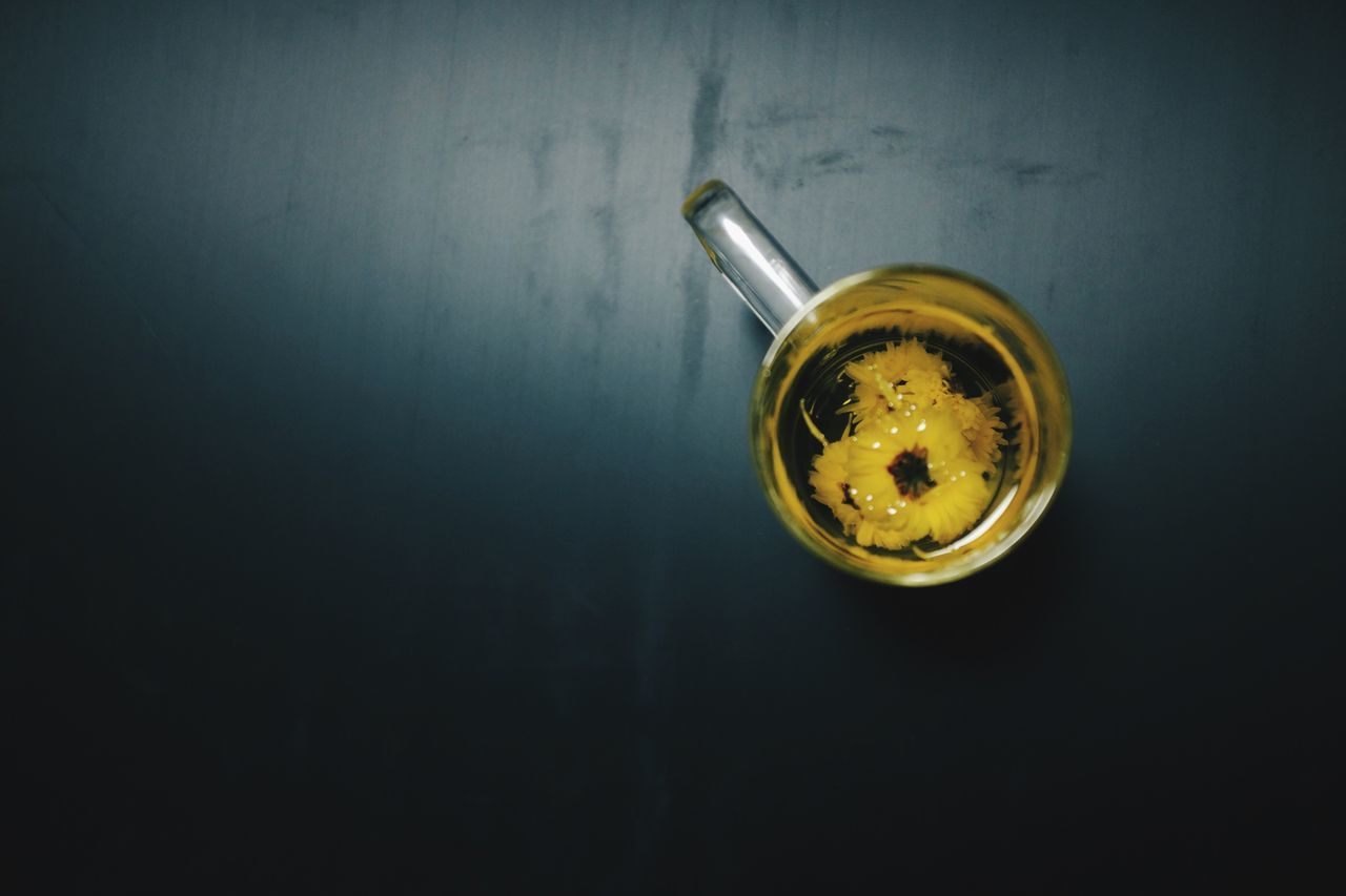 indoors, close-up, still life, glass - material, studio shot, single object, table, drink, copy space, light bulb, no people, drinking glass, transparent, refreshment, lighting equipment, high angle view, reflection, glass, food and drink, electricity