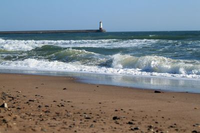 Scenic view of beach against clear sky