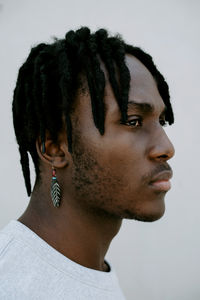 Black man with earring portrait on a monochrome background