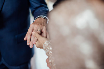 Close-up of couple holding hands