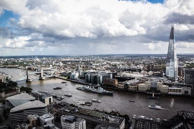 Aerial view of city against cloudy sky