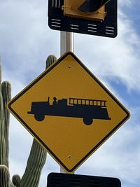 Low angle view of road sign against sky