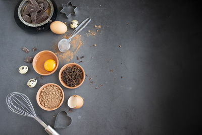 Mix of baking dessert ingredients on dark background, culinary flat lay