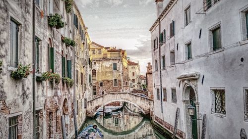 Panoramic view of buildings and bridge in canal