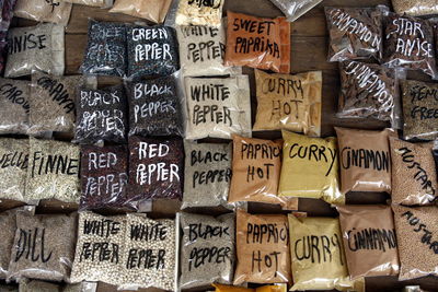 High angle view of grounded spices packets arranged on table for sale