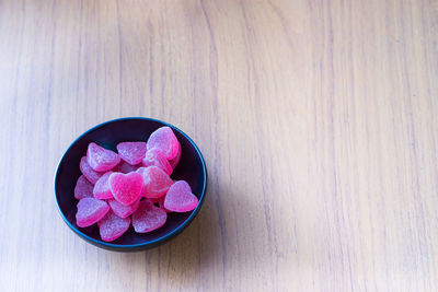 High angle view of multi colored candies in glass on table