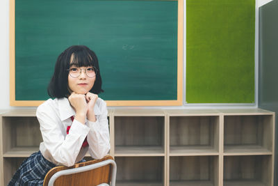 Portrait of a young woman sitting outdoors