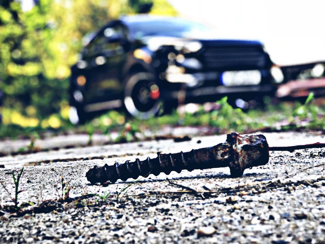 CLOSE-UP OF DAMAGED CAR ON ROAD