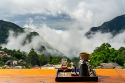 Close-up of coffee on table against mountains