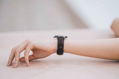 Close-up of hand holding clock