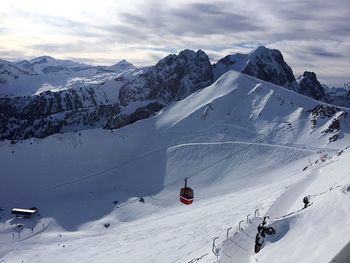 High angle view of ski lift over snowcapped mountains against sky
